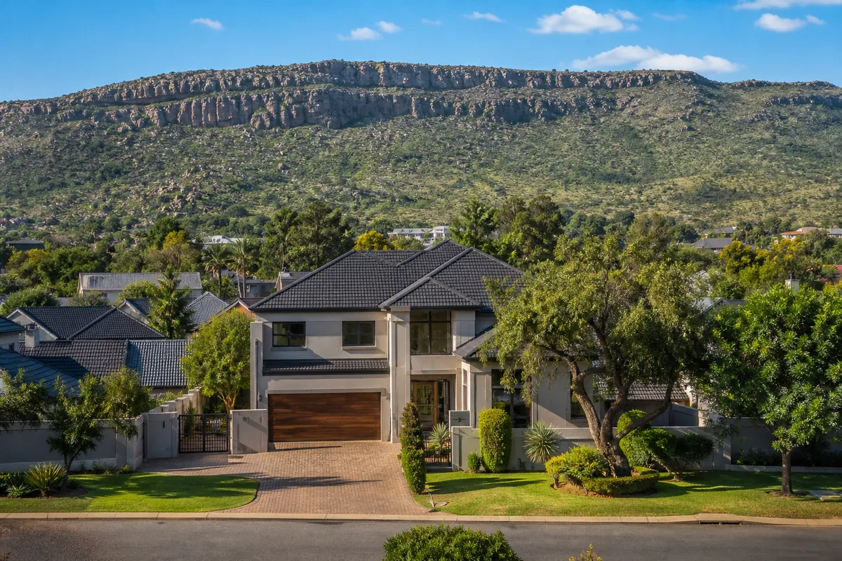 Leafy residential streets with the Bronberg landscape in Faerie Glen, within HoneySucker's Pretoria East septic service coverage